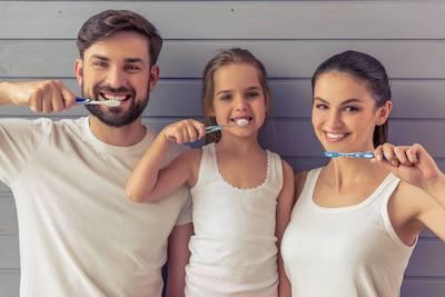 Family brushing teeth | dental bonding West Seattle, WA