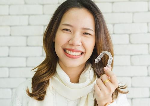 cosmetic dentist west seattle | woman with clear aligners