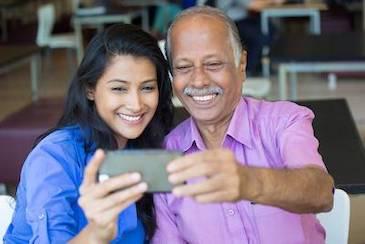 Patient smiling for selfie after receiving SMART safe mercury removal at Holliday Dental Wellness in Seattle, WA