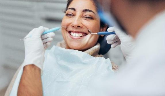 professional teeth whitening seattle | woman at dentist