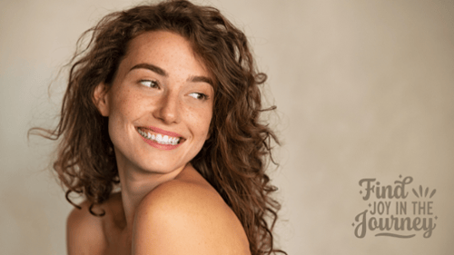 Smiling beautiful lady looking over her shoulder with find joy in the journey written in captions